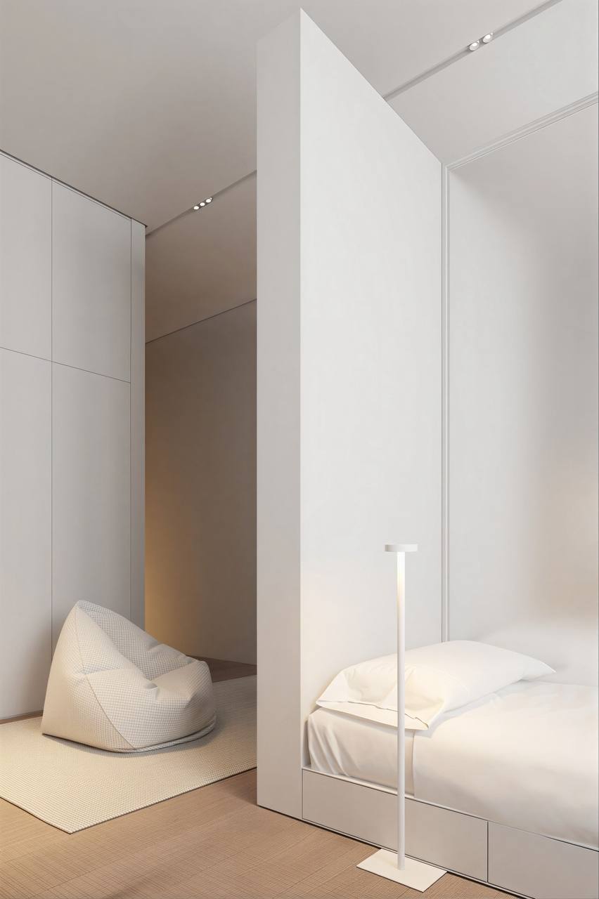 Minimal white bedroom with partition and soft seating